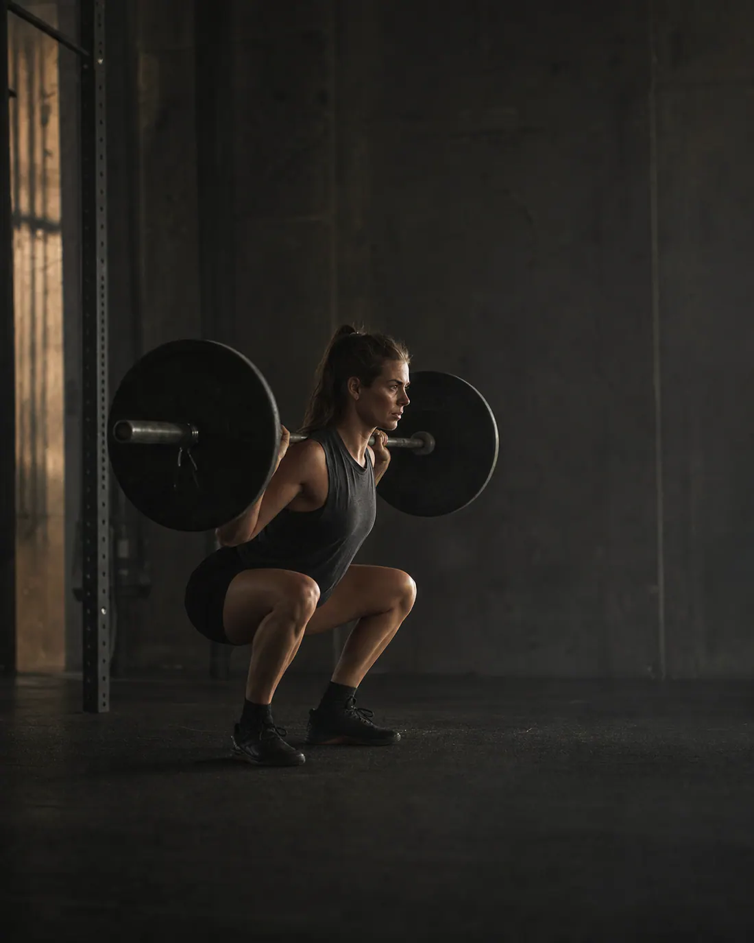 Athlete completing a controlled barbell squat